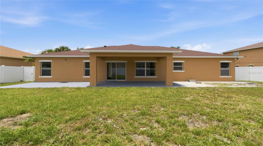 Rear Exterior From Backyard, Covered Lanai. Fully Fenced In