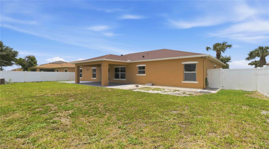 Rear Exterior From Backyard, Covered Lanai. Fully Fenced In