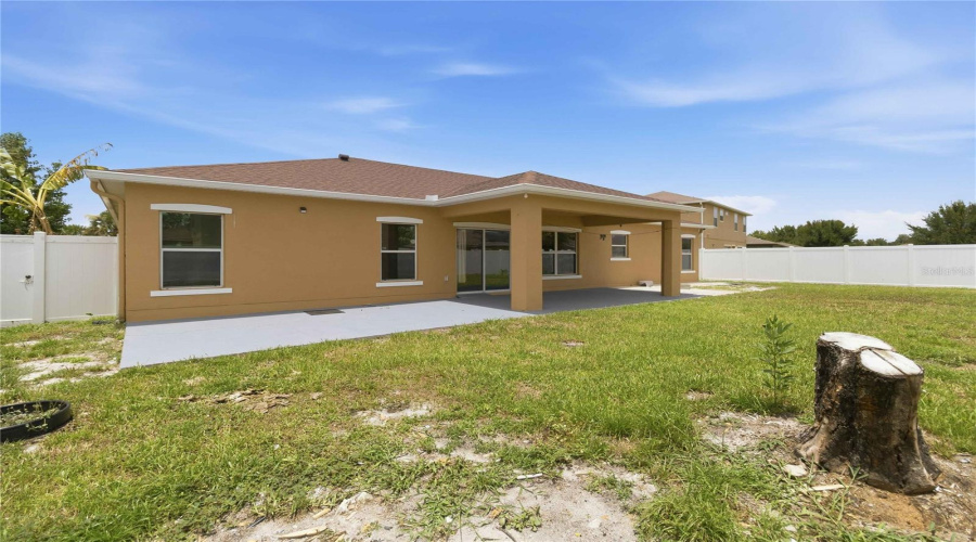 Rear Exterior From Backyard, Covered Lanai. Fully Fenced In