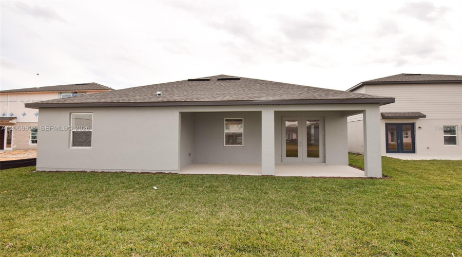 Rear Exterior With Covered Patio And Backyard