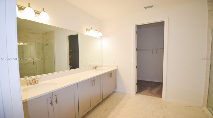 Spacious Primary Bathroom With Dual Vanity