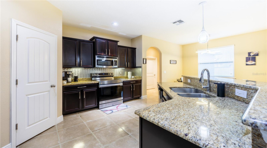 Kitchen With Granite Countertops And Plenty Of Storage