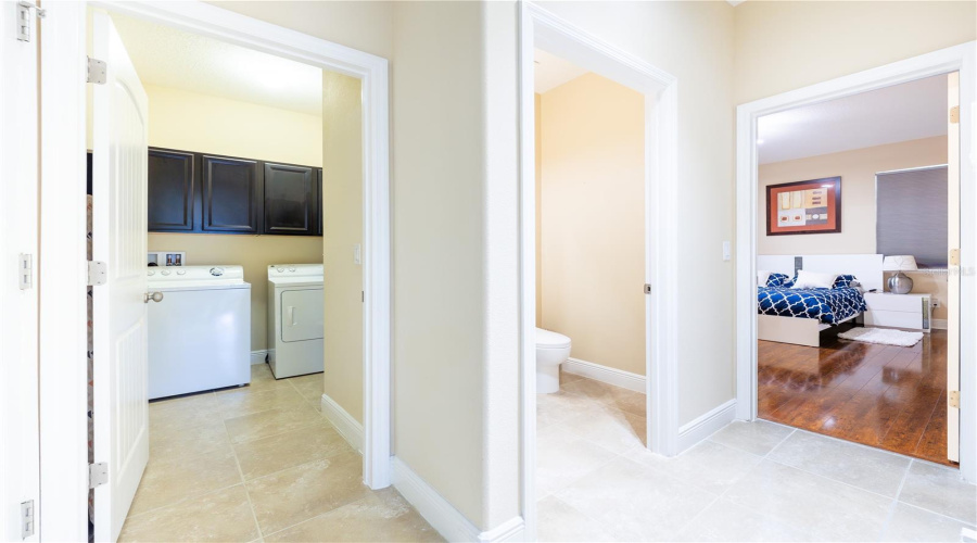 Main-Floor Hallway With Laundry Room And Access To The Primary Suite