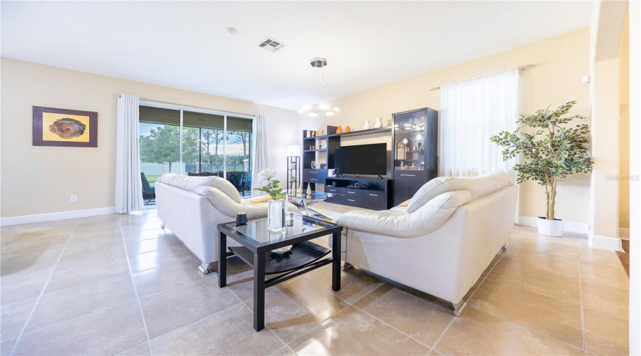 Open-Concept Living Room With Soaring Ceilings And Sliding Glass Doors
