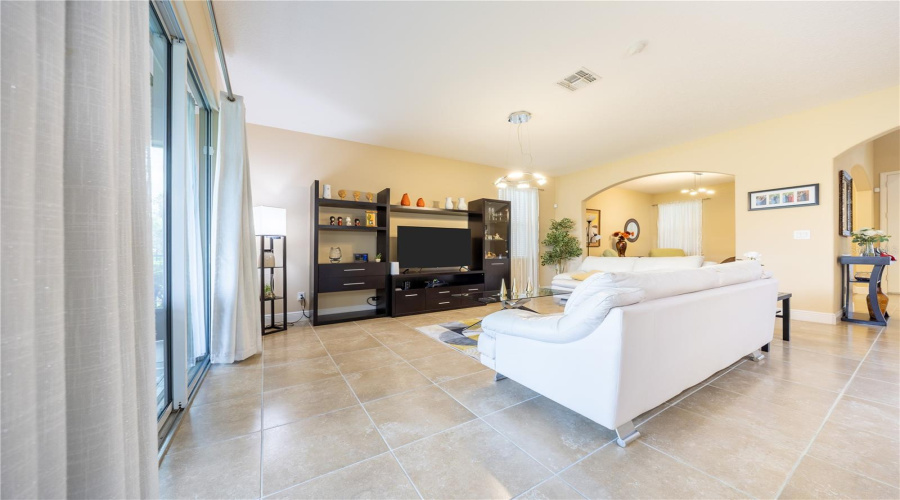 Spacious Living Room With Soaring Ceilings And Natural Light