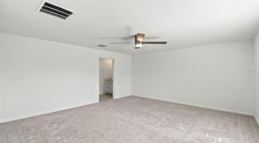 The Private Owner’s Suite Is Tucked Away At The Back Of The Home And Features An En-Suite Bathroom With Dual Sinks, A Walk-In Shower, And A Generous Walk-In Closet.