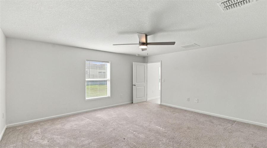 The Private Owner’s Suite Is Tucked Away At The Back Of The Home And Features An En-Suite Bathroom With Dual Sinks, A Walk-In Shower, And A Generous Walk-In Closet.