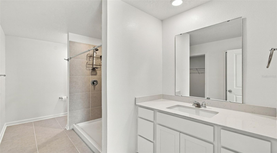 The Private Owner’s Suite Is Tucked Away At The Back Of The Home And Features An En-Suite Bathroom With Dual Sinks, A Walk-In Shower, And A Generous Walk-In Closet.