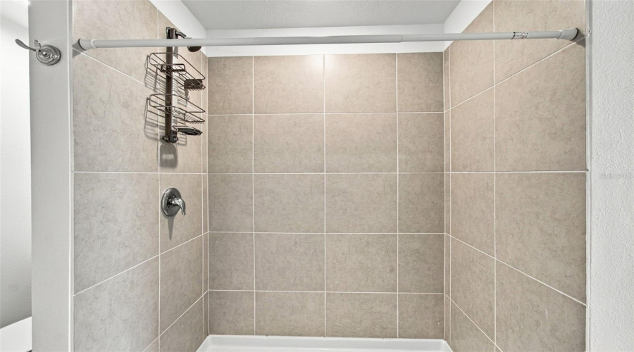 The Private Owner’s Suite Is Tucked Away At The Back Of The Home And Features An En-Suite Bathroom With Dual Sinks, A Walk-In Shower, And A Generous Walk-In Closet.