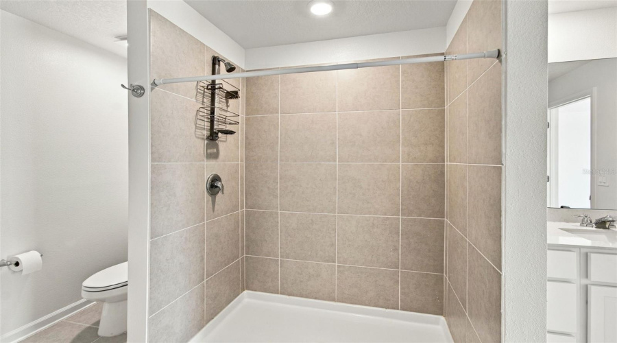 The Private Owner’s Suite Is Tucked Away At The Back Of The Home And Features An En-Suite Bathroom With Dual Sinks, A Walk-In Shower, And A Generous Walk-In Closet.