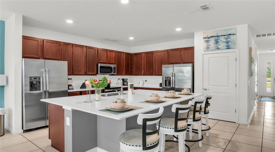 Kitchen With Double Refrigerator And Stainless Steel Appliances