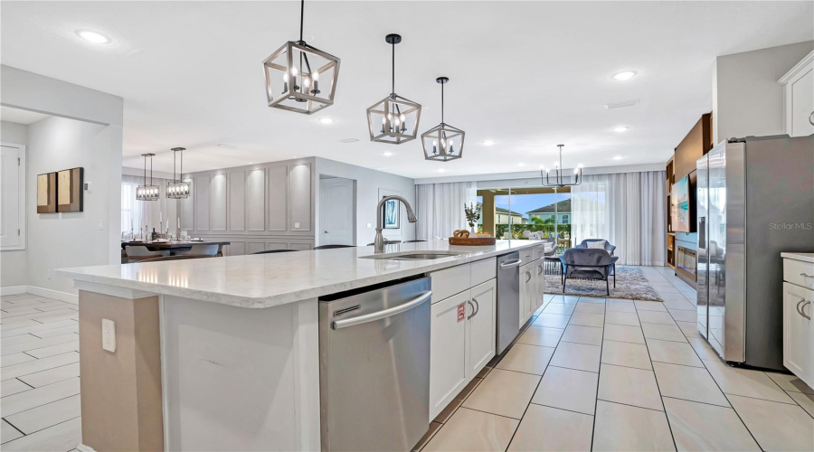 An Expansive Kitchen With Oversized Island Opens Directly To The Main Gathering Spaces, Creating A Seamless Environment For Entertaining Large Groups